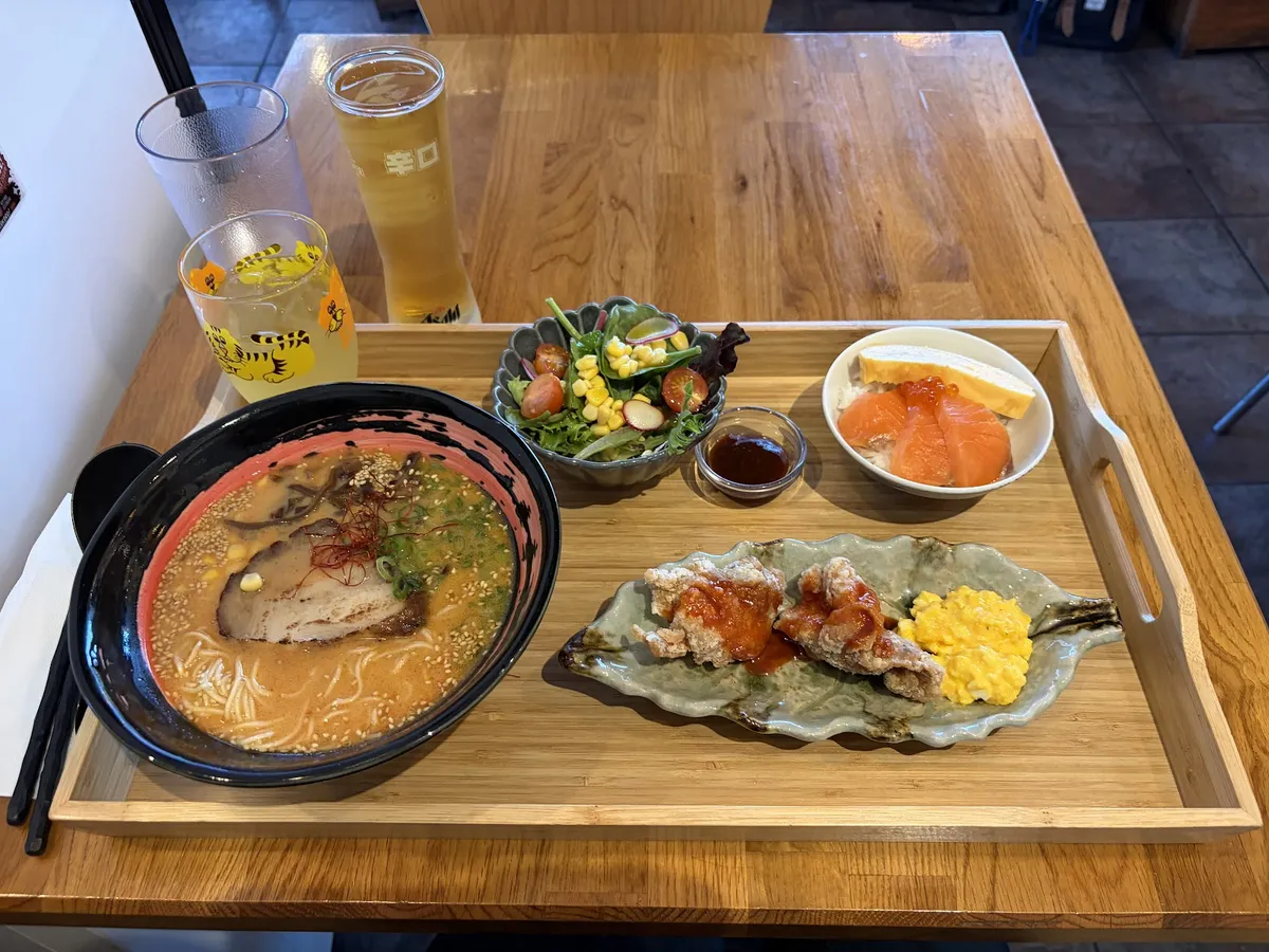 Ramen, fried chicken, salad, salmon sashimi, and drinks